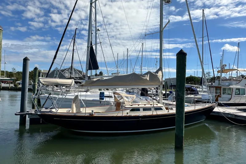 Ibis Yacht Photos Pics Sailboat docked in marina, Morris M36, 2006 model, under a clear blue sky.