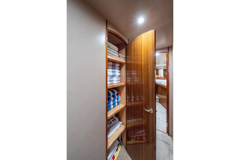 Big Blue Yacht Photos Pics Luxurious wooden cabinet with neatly stacked towels inside a 2007 Viking 64 Convertible yacht.