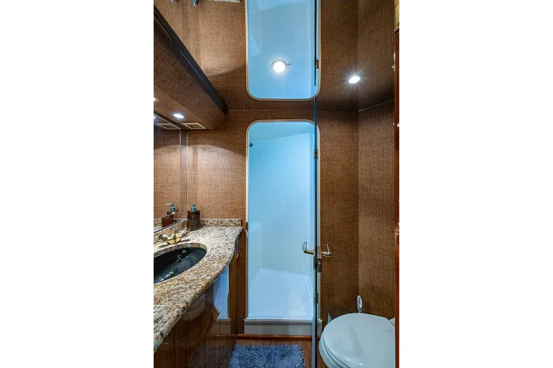 Big Blue Yacht Photos Pics Luxurious bathroom interior of 2007 Viking 64 Convertible yacht with granite countertop.