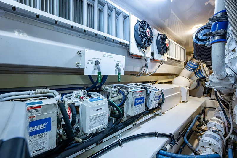 Big Blue Yacht Photos Pics Engine room of 2007 Viking 64 Convertible yacht, showcasing mechanical components and systems.