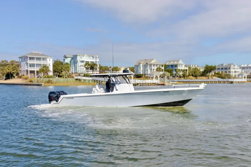  Yacht Photos Pics 2020 Contender 39 ST boat cruising near waterfront homes.