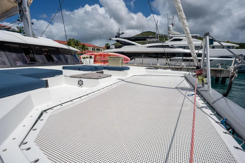  Yacht Photos Pics 2020 Fountaine Pajot SABA 50 catamaran deck with netting, docked in a marina.