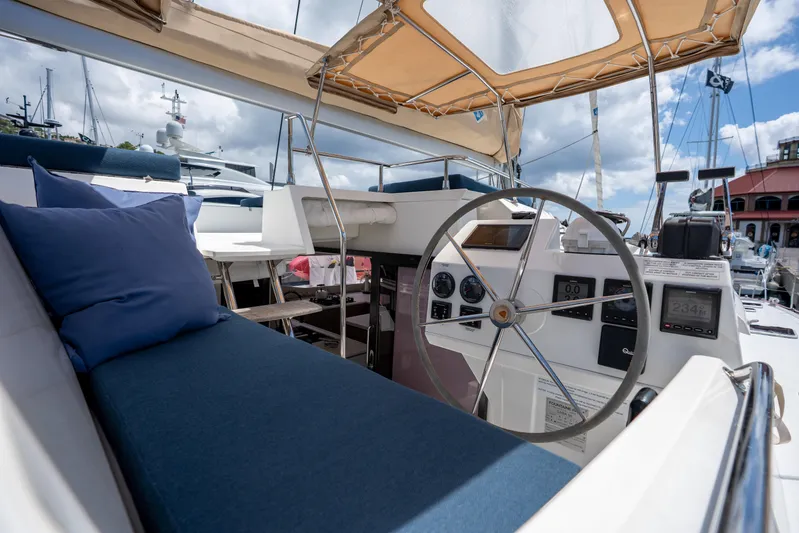  Yacht Photos Pics 2020 Fountaine Pajot SABA 50 yacht helm with blue seating and canopy.