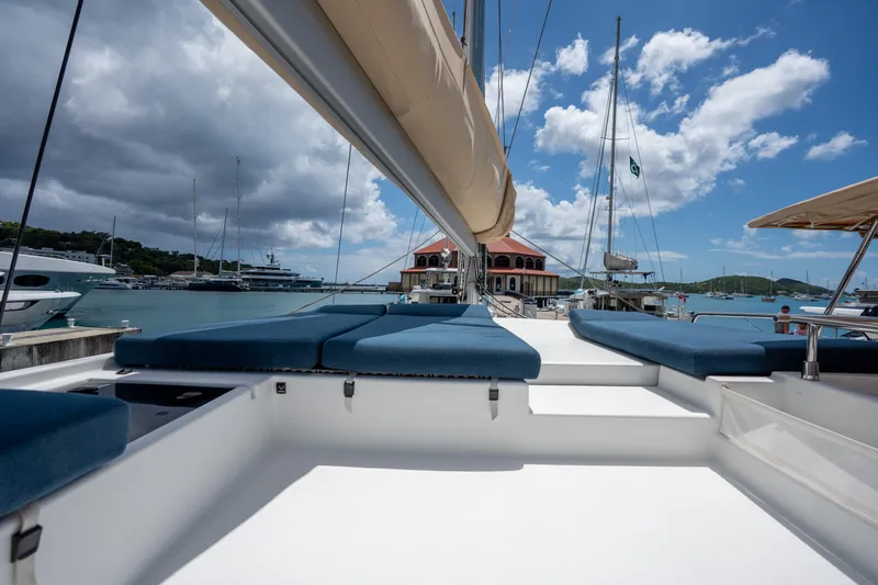  Yacht Photos Pics 2020 Fountaine Pajot SABA 50 catamaran docked, featuring spacious deck and blue cushions under a sunny sky.