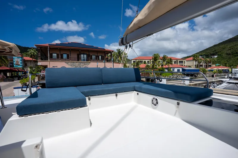  Yacht Photos Pics 2020 Fountaine Pajot SABA 50 yacht with blue seating, docked at a marina.