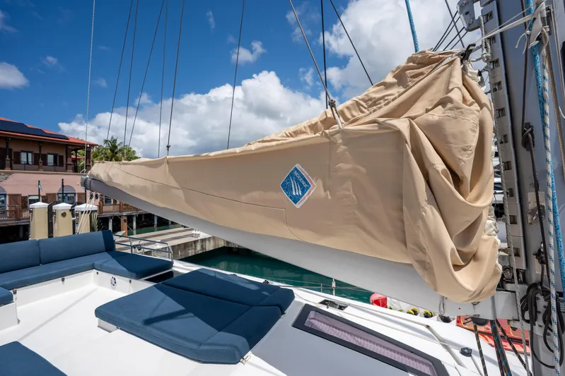  Yacht Photos Pics 2020 Fountaine Pajot SABA 50 sailboat with covered sail, docked under blue sky.