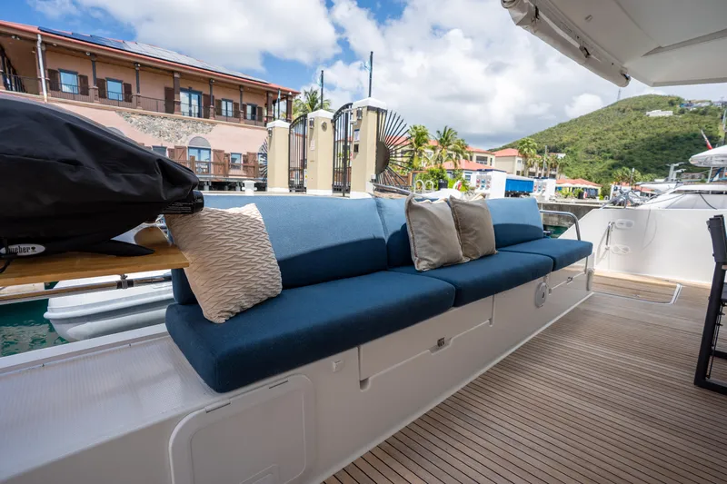  Yacht Photos Pics Luxurious seating area on a 2020 Fountaine Pajot SABA 50 yacht, docked at a scenic marina.