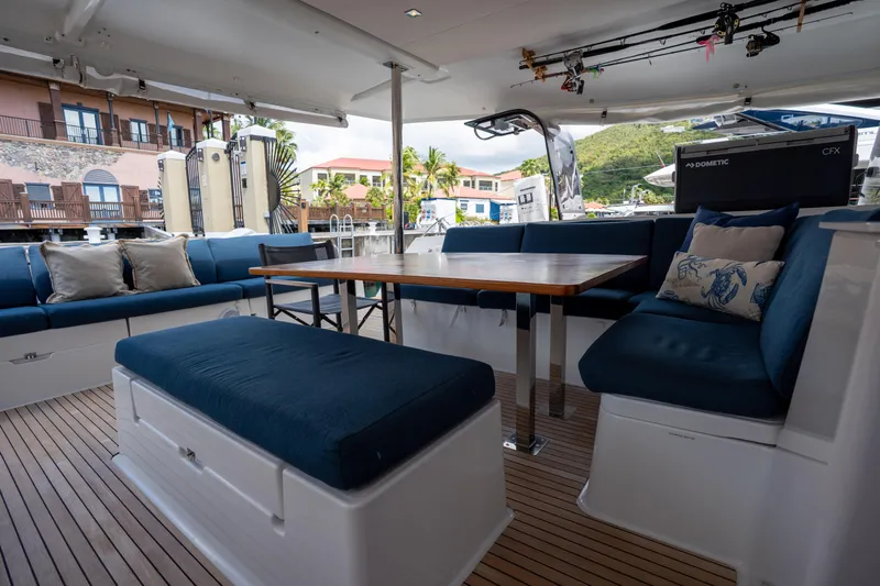  Yacht Photos Pics Spacious outdoor seating area on 2020 Fountaine Pajot SABA 50 catamaran with blue cushions.