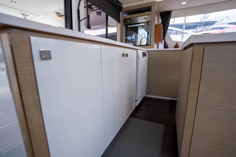  Yacht Photos Pics Modern kitchen interior of 2020 Fountaine Pajot SABA 50 catamaran with sleek cabinetry.