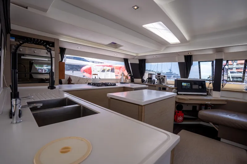  Yacht Photos Pics Modern kitchen interior of 2020 Fountaine Pajot SABA 50 catamaran with sleek design and appliances.