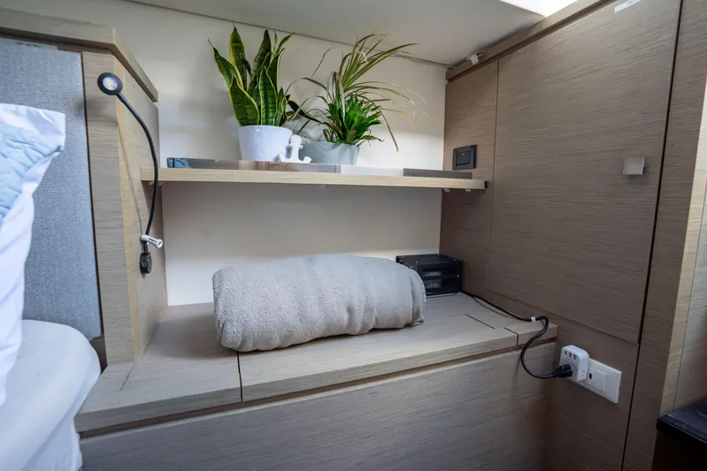  Yacht Photos Pics Cozy cabin interior of 2020 Fountaine Pajot SABA 50 with plants and shelf.