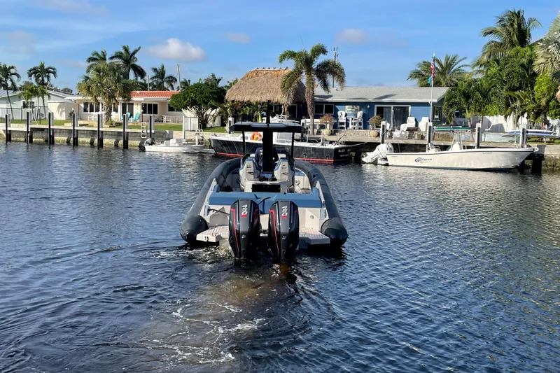  Yacht Photos Pics 2023 Skipper-BSK BSK 38 boat on a sunny waterfront with palm trees.