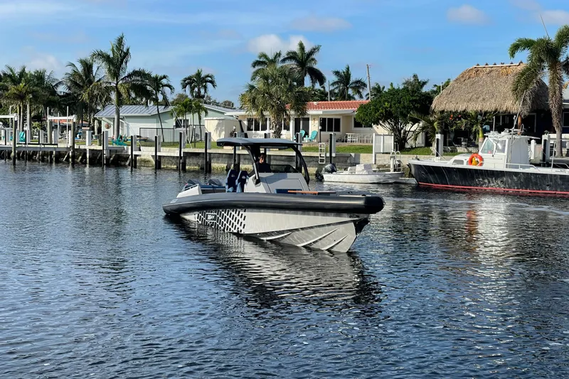  Yacht Photos Pics 2023 Skipper-BSK BSK 38 boat on calm water near a tropical dock.