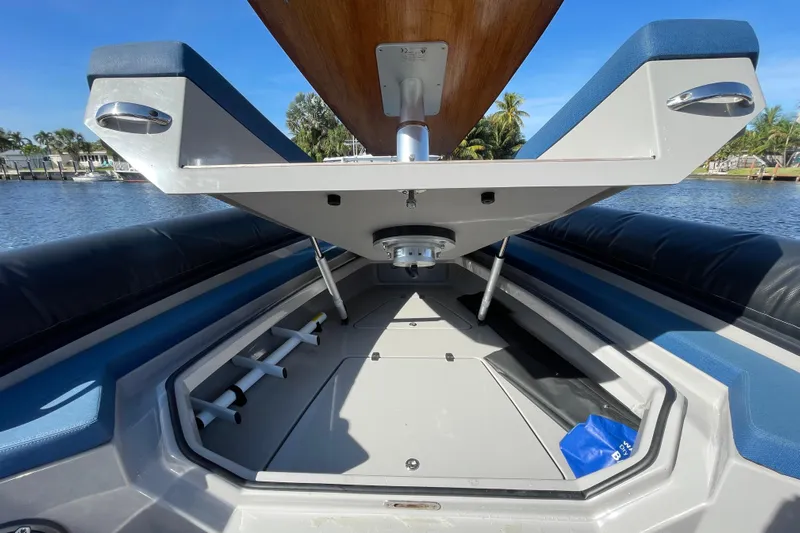  Yacht Photos Pics 2023 Skipper-BSK BSK 38 boat interior with open storage compartment, blue and gray seating.