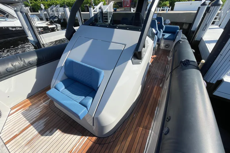  Yacht Photos Pics 2023 Skipper-BSK BSK 38 boat with sleek design and blue seating on wooden deck.