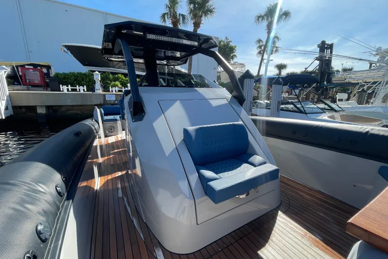  Yacht Photos Pics 2023 Skipper-BSK BSK 38 boat with sleek design and comfortable seating, docked under sunny skies.