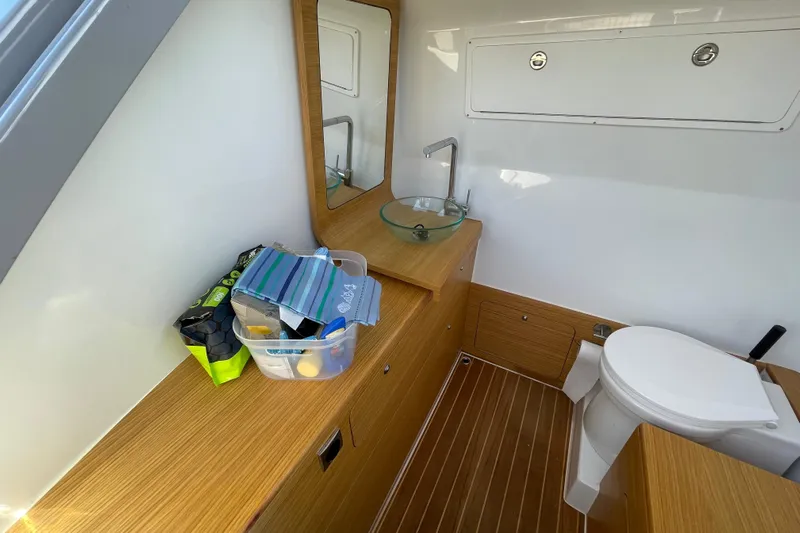  Yacht Photos Pics Modern bathroom interior on Skipper-BSK 38 boat, featuring wood accents and compact design.