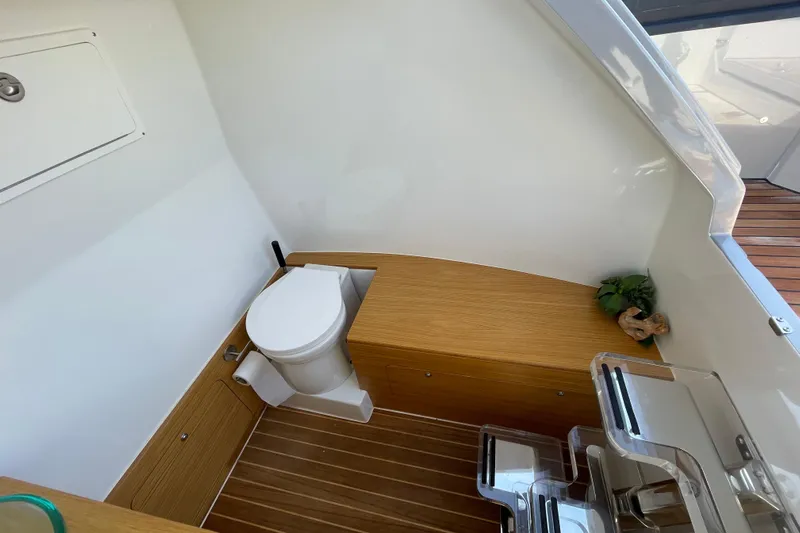  Yacht Photos Pics Modern boat bathroom with wooden accents, featuring a toilet and storage, Skipper-BSK BSK 38, 2023.