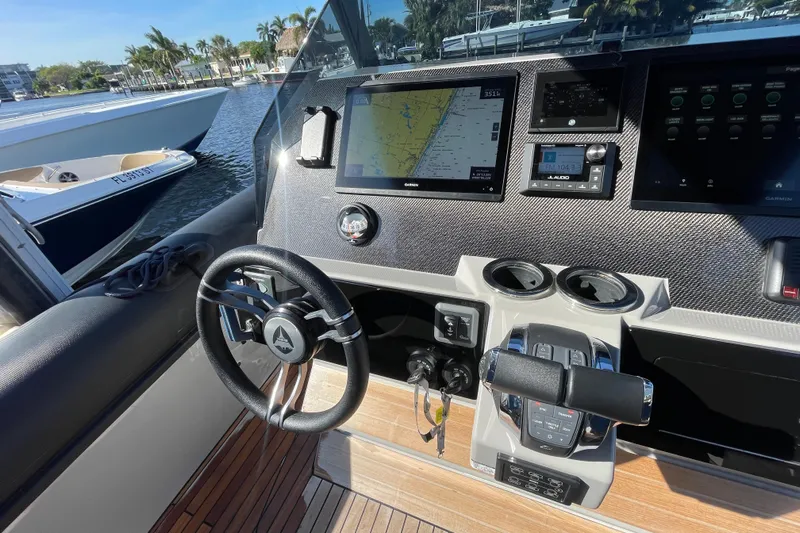  Yacht Photos Pics Cockpit of 2023 Skipper-BSK BSK 38 boat with advanced navigation system and steering wheel.