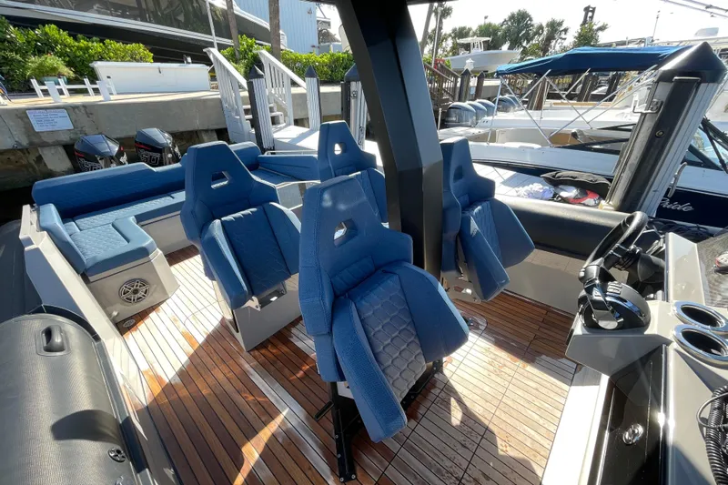  Yacht Photos Pics 2023 Skipper-BSK BSK 38 boat interior with blue seats and wooden deck.