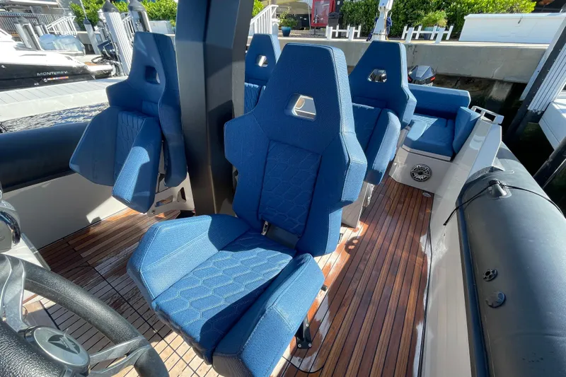  Yacht Photos Pics 2023 Skipper-BSK BSK 38 boat interior with blue seats and wooden deck.