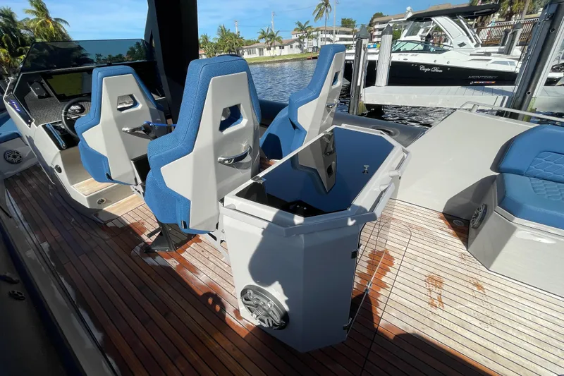  Yacht Photos Pics 2023 Skipper-BSK BSK 38 boat interior with blue seats and wooden deck.