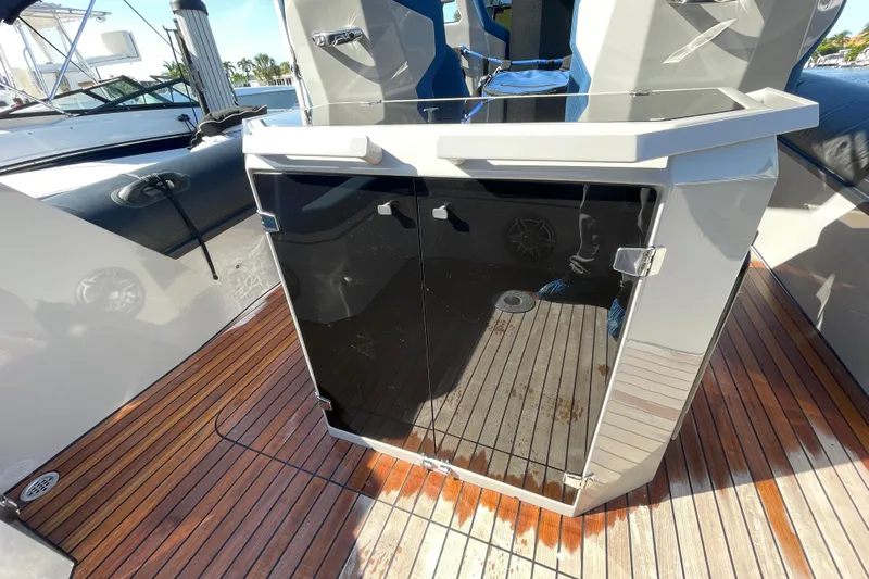  Yacht Photos Pics 2023 Skipper-BSK BSK 38 boat with sleek black console and wooden deck.