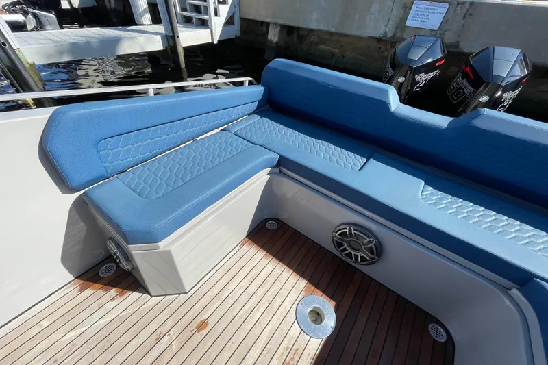  Yacht Photos Pics Blue seating on 2023 Skipper-BSK BSK 38 boat with wooden deck and speakers.