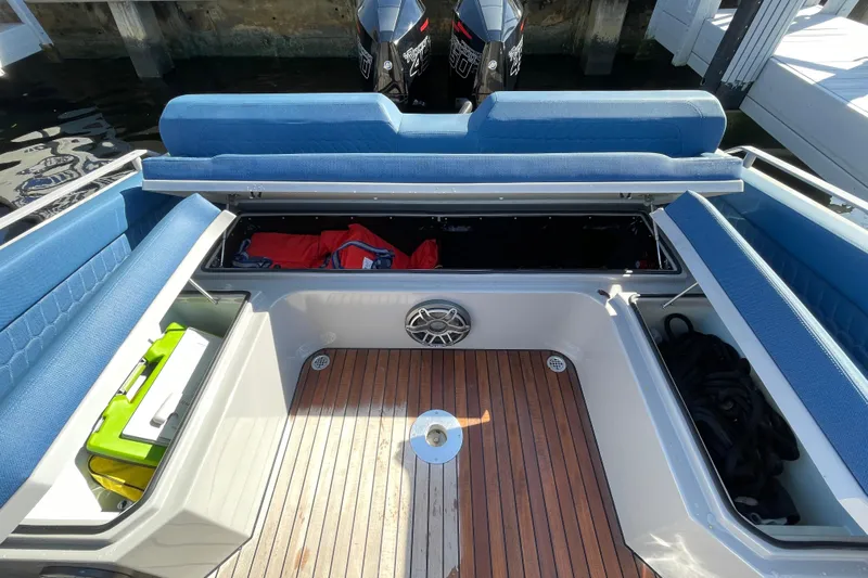 Yacht Photos Pics 2023 Skipper-BSK BSK 38 boat interior with blue seating and storage compartments.
