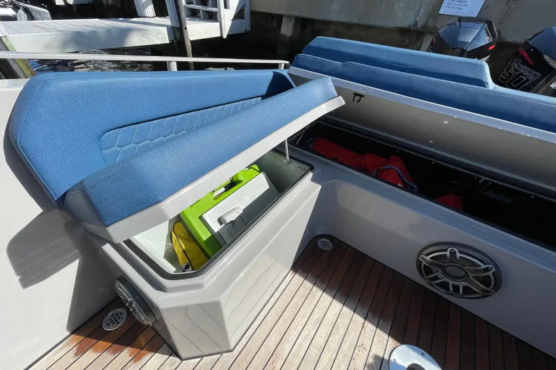 Yacht Photos Pics 2023 Skipper-BSK BSK 38 boat with open storage compartments and blue seating.
