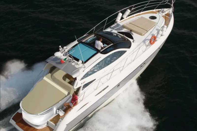  Yacht Photos Pics 2006 Cranchi Mediterranee 47 HT yacht cruising on open water.