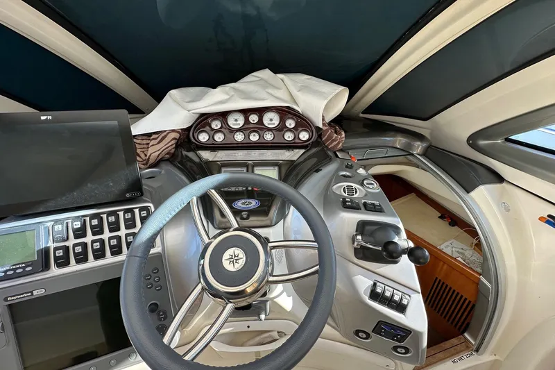  Yacht Photos Pics Helm of 2006 Cranchi Mediterranee 47 HT yacht with steering wheel and control panel.