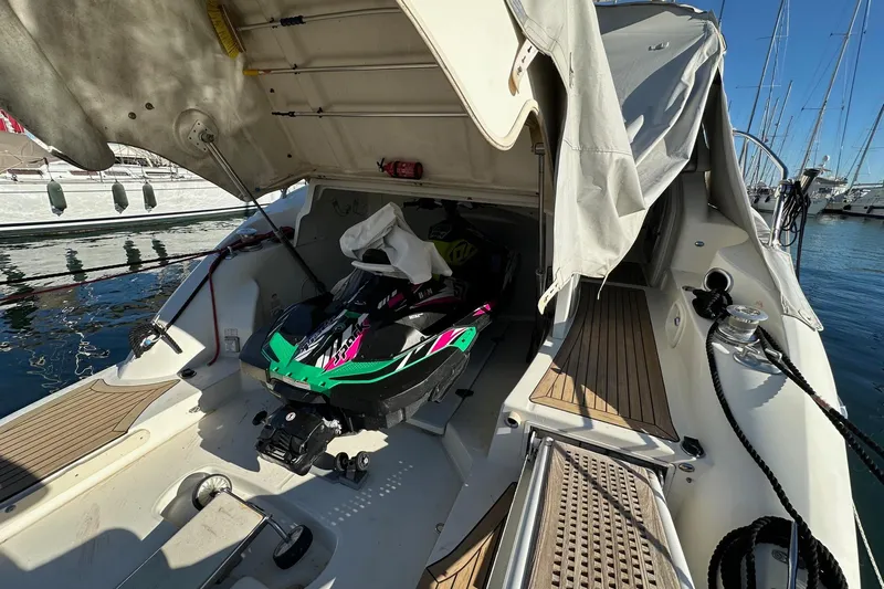  Yacht Photos Pics 2006 Cranchi Mediterranee 47 HT yacht with a jet ski in the storage compartment.