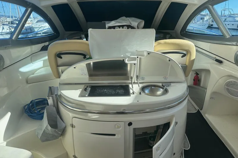  Yacht Photos Pics Luxurious 2006 Cranchi Mediterranee 47 HT yacht interior with kitchenette and seating area.