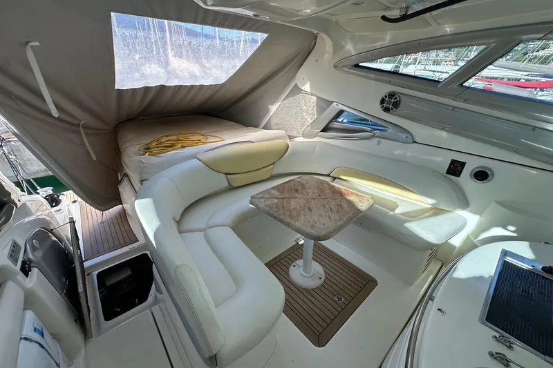  Yacht Photos Pics Luxurious interior of 2006 Cranchi Mediterranee 47 HT yacht with elegant seating and table.