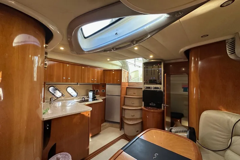  Yacht Photos Pics Luxurious interior of 2006 Cranchi Mediterranee 47 HT yacht with elegant wood finishes.