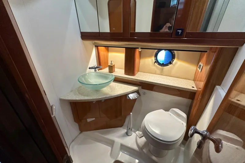  Yacht Photos Pics Luxurious bathroom in 2006 Cranchi Mediterranee 47 HT yacht with modern fixtures and porthole.