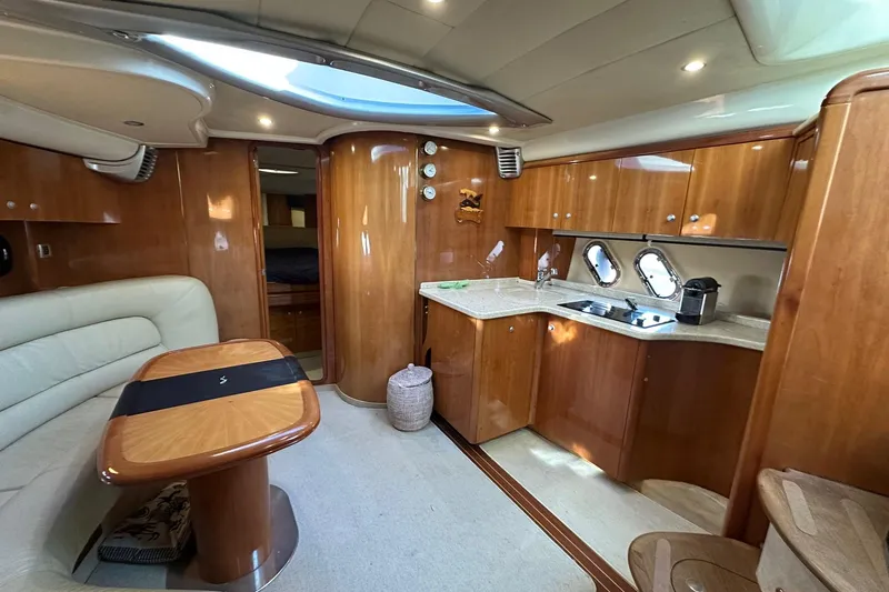  Yacht Photos Pics Luxurious interior of 2006 Cranchi Mediterranee 47 HT yacht with wood finishes and modern amenities.