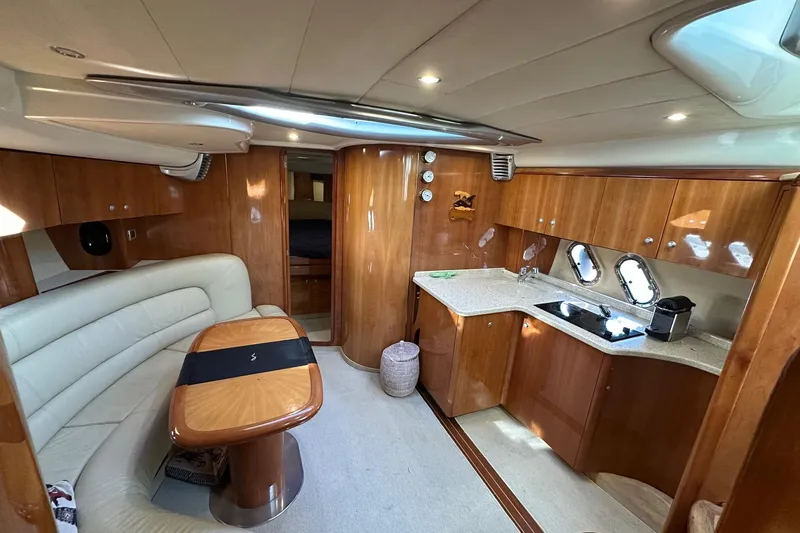  Yacht Photos Pics Luxurious interior of 2006 Cranchi Mediterranee 47 HT yacht with elegant wood finish.
