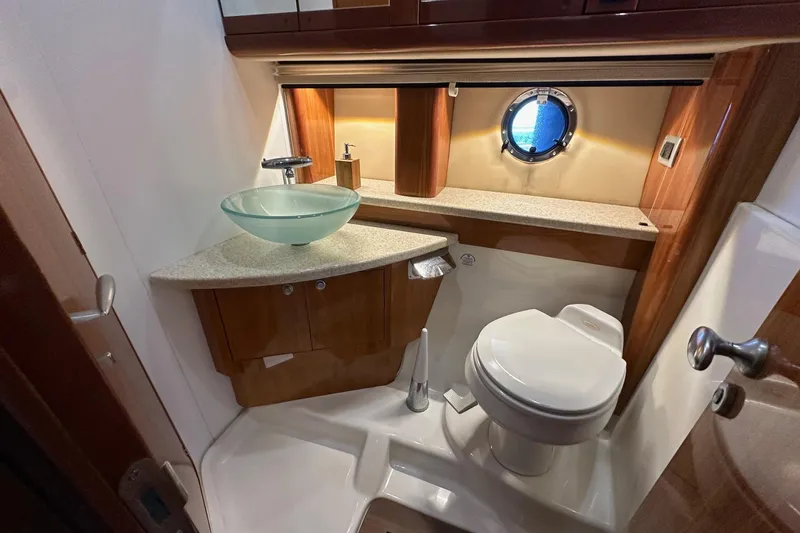  Yacht Photos Pics Luxurious bathroom in 2006 Cranchi Mediterranee 47 HT yacht with modern fixtures and porthole window.