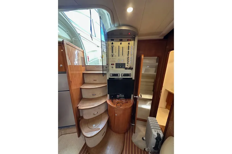  Yacht Photos Pics Interior of 2006 Cranchi Mediterranee 47 HT yacht with wooden stairs and control panel.