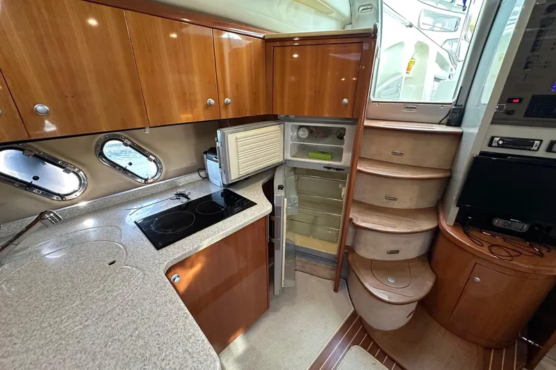  Yacht Photos Pics Luxurious 2006 Cranchi Mediterranee 47 HT yacht interior with modern kitchen and elegant wood finishes.