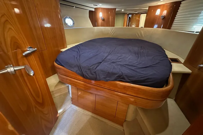  Yacht Photos Pics Luxurious cabin interior of 2006 Cranchi Mediterranee 47 HT yacht with wooden finishes.