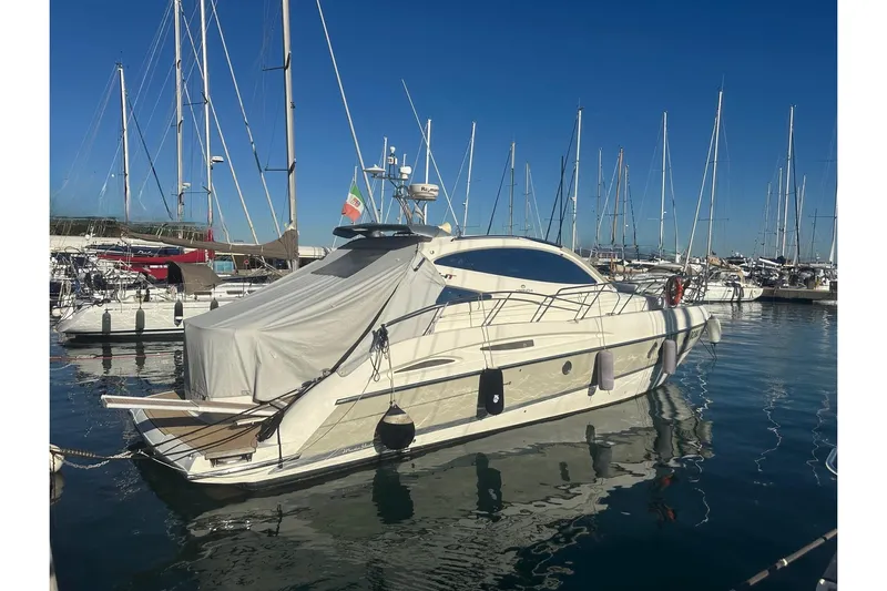  Yacht Photos Pics 2006 Cranchi Mediterranee 47 HT yacht docked in a marina, surrounded by sailboats.