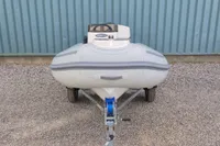 2024 AB Inflatables 10 ALX boat on trailer, parked on gravel.