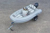 2024 AB Inflatables 10 ALX boat on trailer, gray with seating and outboard motor.