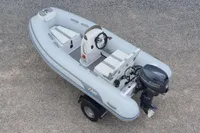 2024 AB Inflatables 10 ALX boat with Yamaha outboard motor on gravel surface.