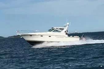  Yacht Photos Pics 1998 Tiara Yachts 3700 Open cruising on the ocean with American flag.