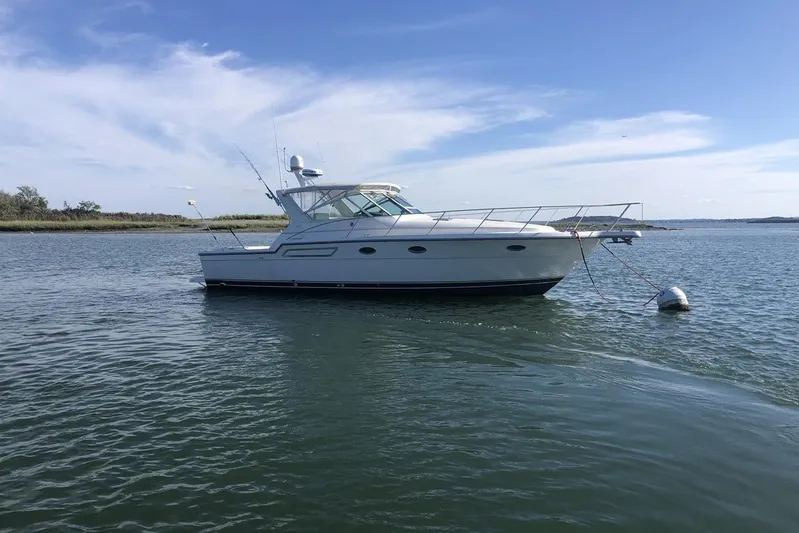  Yacht Photos Pics 1998 Tiara Yachts 3700 Open anchored on calm water under a clear blue sky.