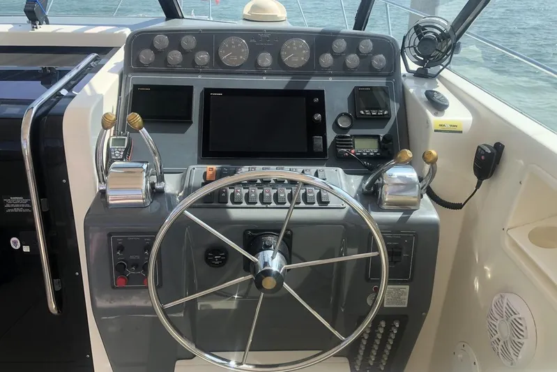  Yacht Photos Pics 1998 Tiara Yachts 3700 Open helm with steering wheel and control panel.